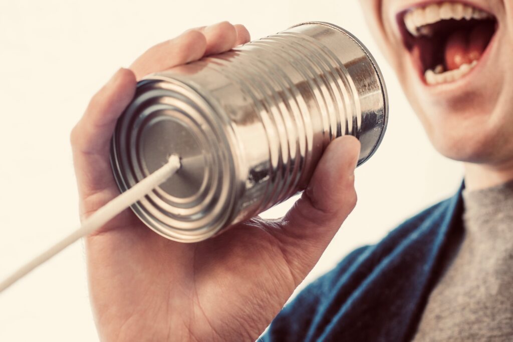 Someone speaking through a tin can and string