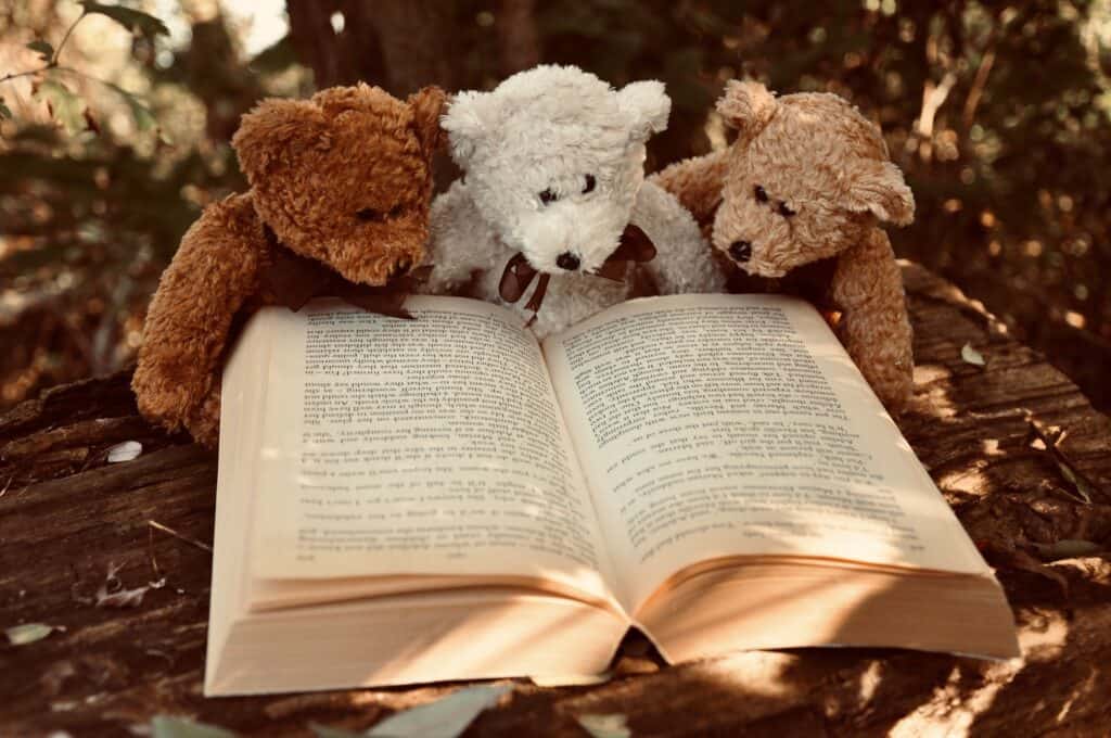 Good conduct commands respect. Three differently coloured teddy bears reading a book. 