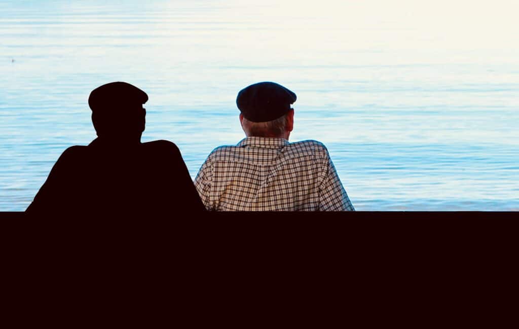 Man looking at the beach and his silhouette. Paranoia.