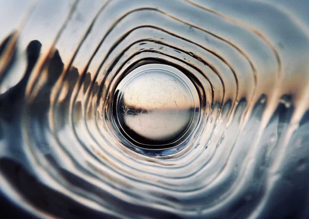 Looking through the bottom of transparent plastic bottle. Are we truly free?