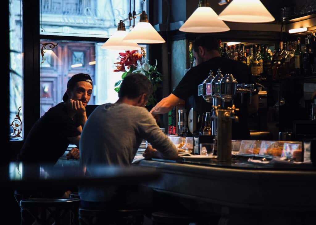 Two men in a bar. Friends. 