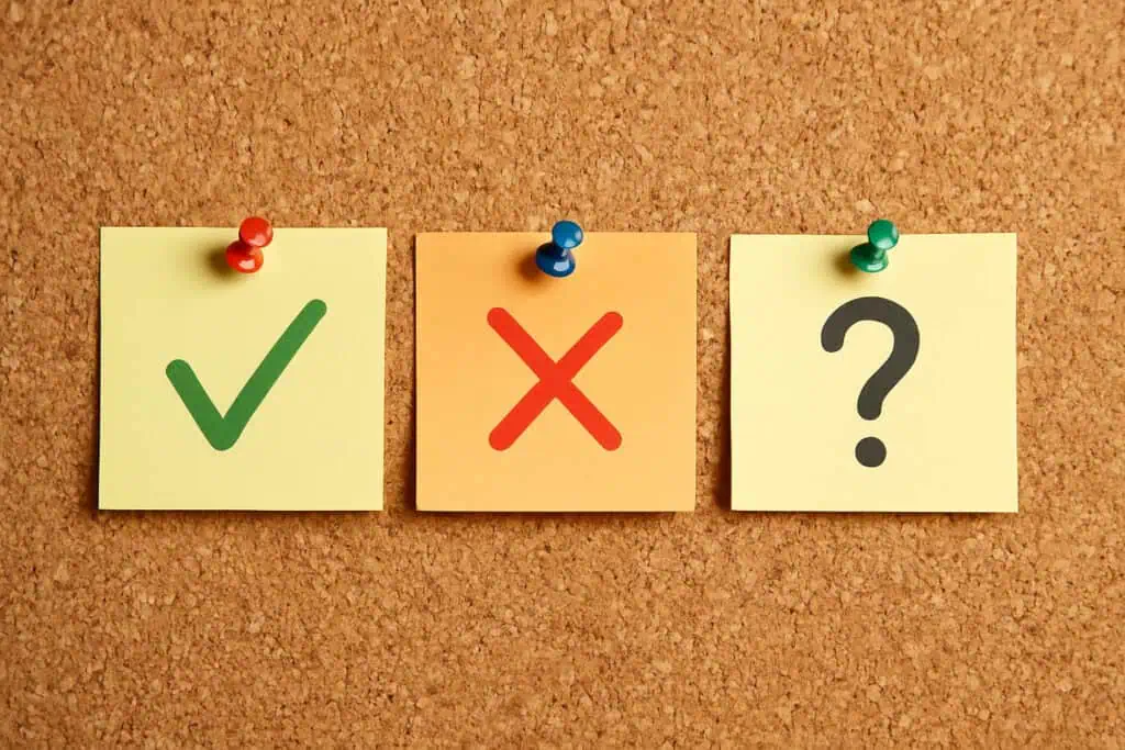 Corkboard with checkmark, X, question notes